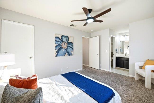 8550 Wren Avenue, Unit 3B Gilroy, CA 95020 - Photo 15 of 27 a bedroom with a bed and a chandelier