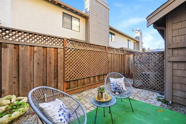 8550 Wren Avenue, Unit 3B Gilroy, CA 95020 - Photo 18 of 27 a backyard of a house with table and chairs