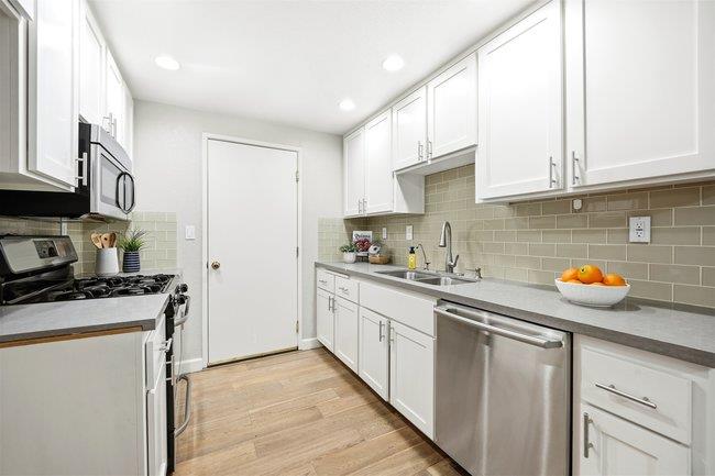 8550 Wren Avenue, Unit 3B Gilroy, CA 95020 - Photo 4 of 27 a kitchen with stainless steel appliances granite countertop a sink stove and cabinets