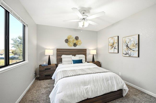 8550 Wren Avenue, Unit 3B Gilroy, CA 95020 - Photo 8 of 27 a bedroom with a bed and a chandelier