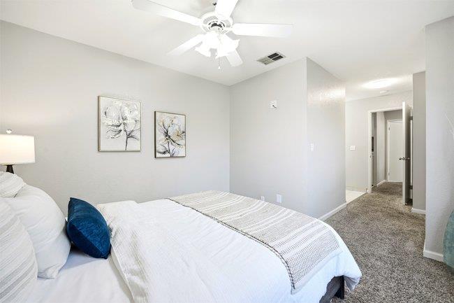 8550 Wren Avenue, Unit 3B Gilroy, CA 95020 - Photo 9 of 27 a bedroom with a large bed and a chandelier