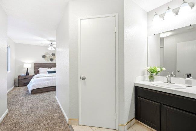 8550 Wren Avenue, Unit 3B Gilroy, CA 95020 - Photo 10 of 27 a en suite bathroom with a double vanity sink and mirror