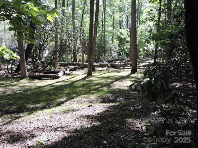a backyard of a house with trees and outdoor seating