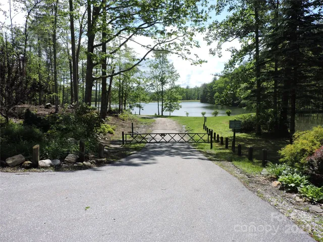 a front view of a house with a yard and lake view