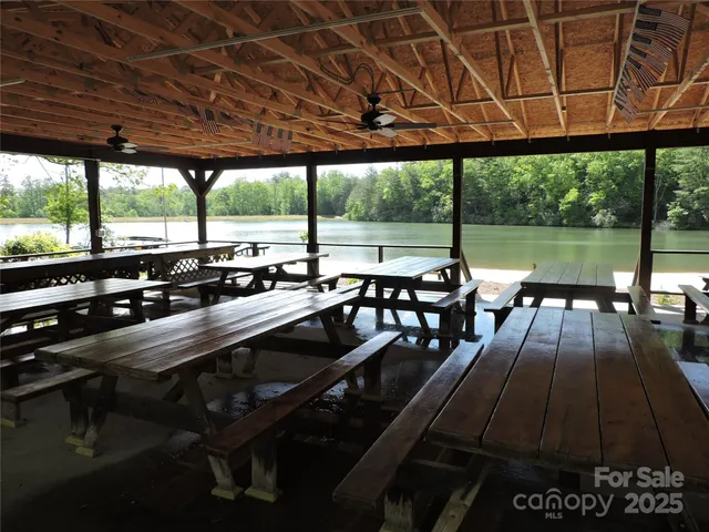 a view of a patio with lawn chairs next to a yard
