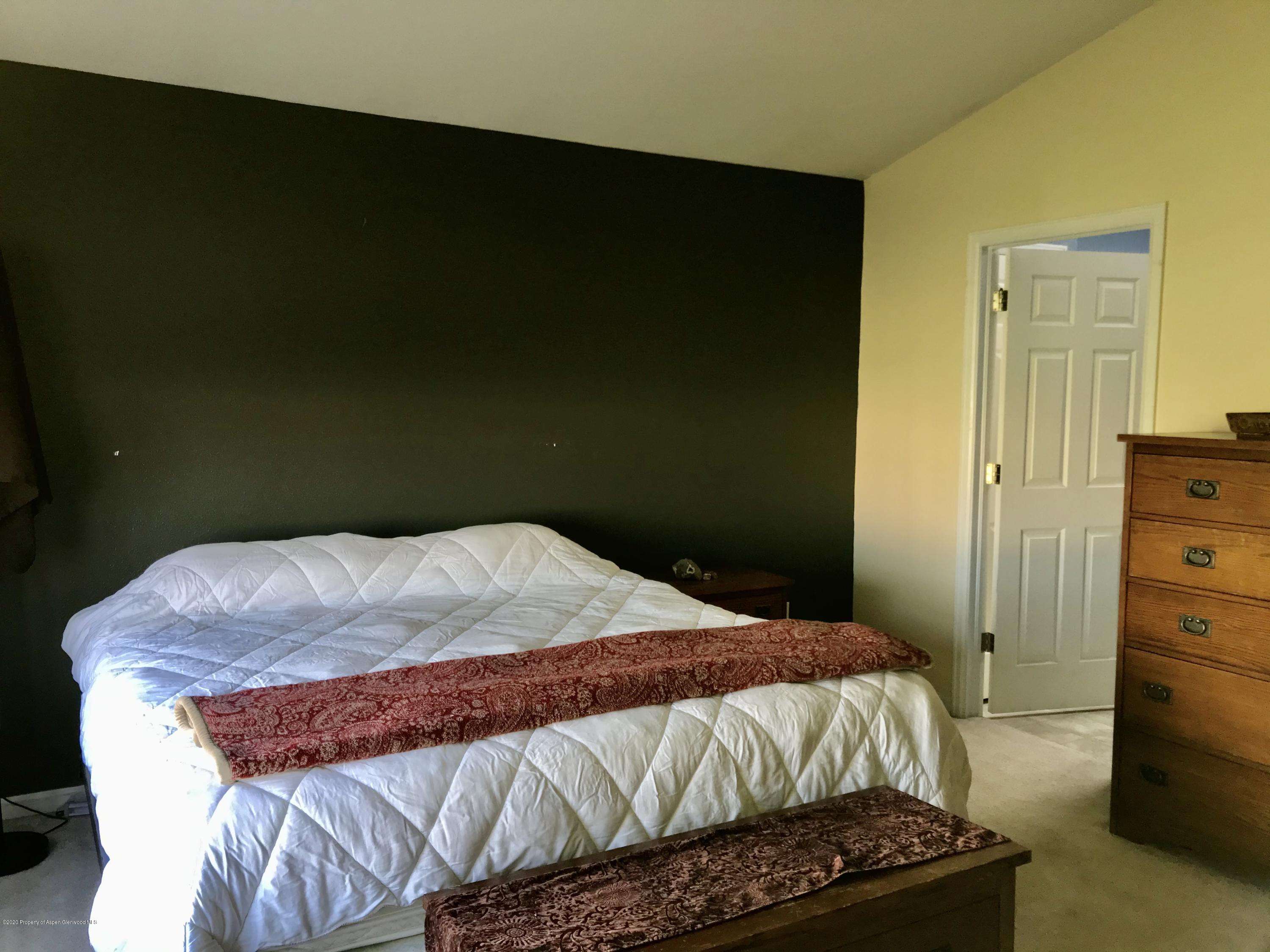 16 Limberpine Circle Parachute, CO 81635 - Photo 14 of 22 a bedroom with a bed and a dresser