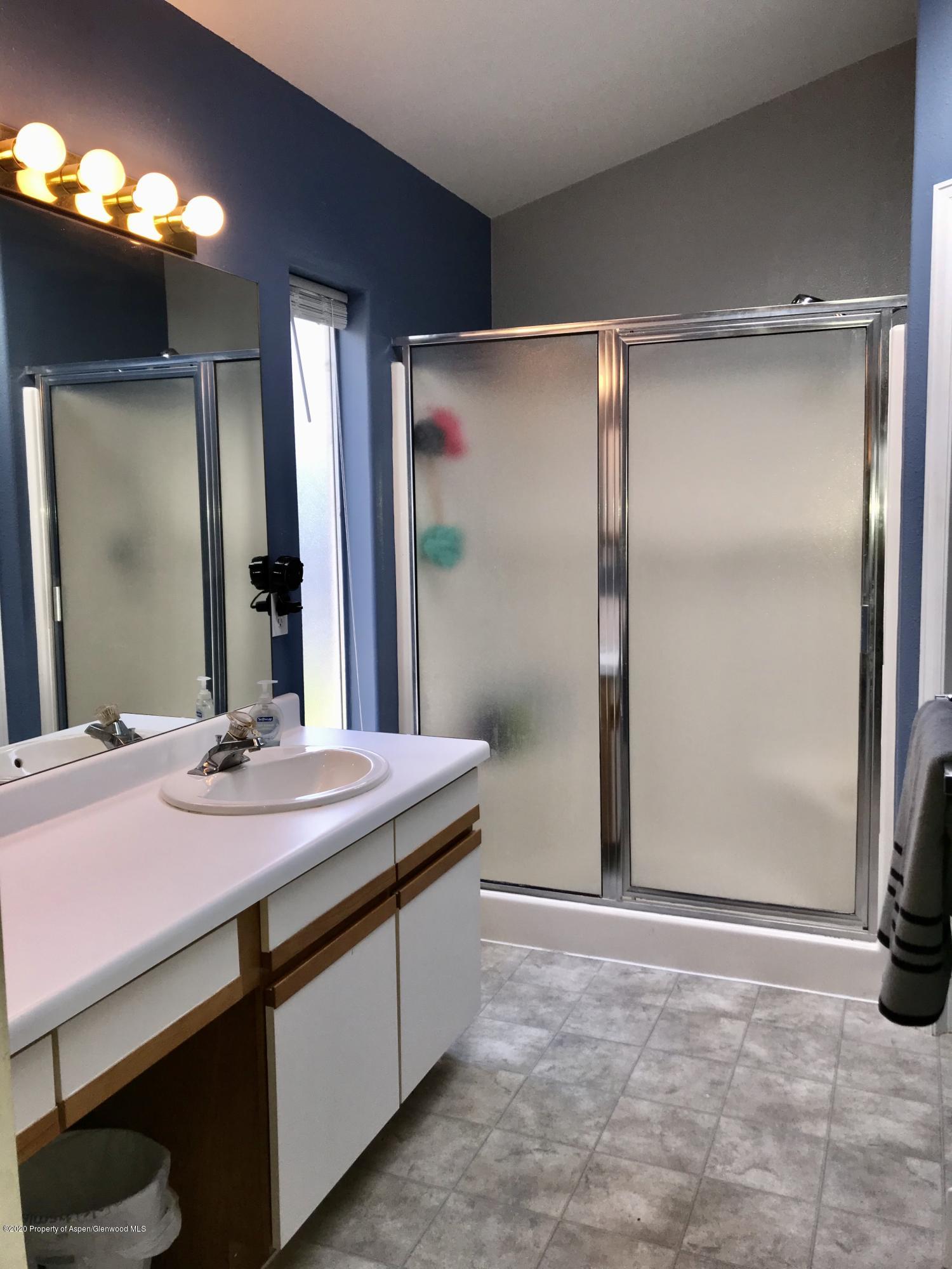 16 Limberpine Circle Parachute, CO 81635 - Photo 17 of 22 a spacious bathroom with a granite countertop sink a mirror and a shower