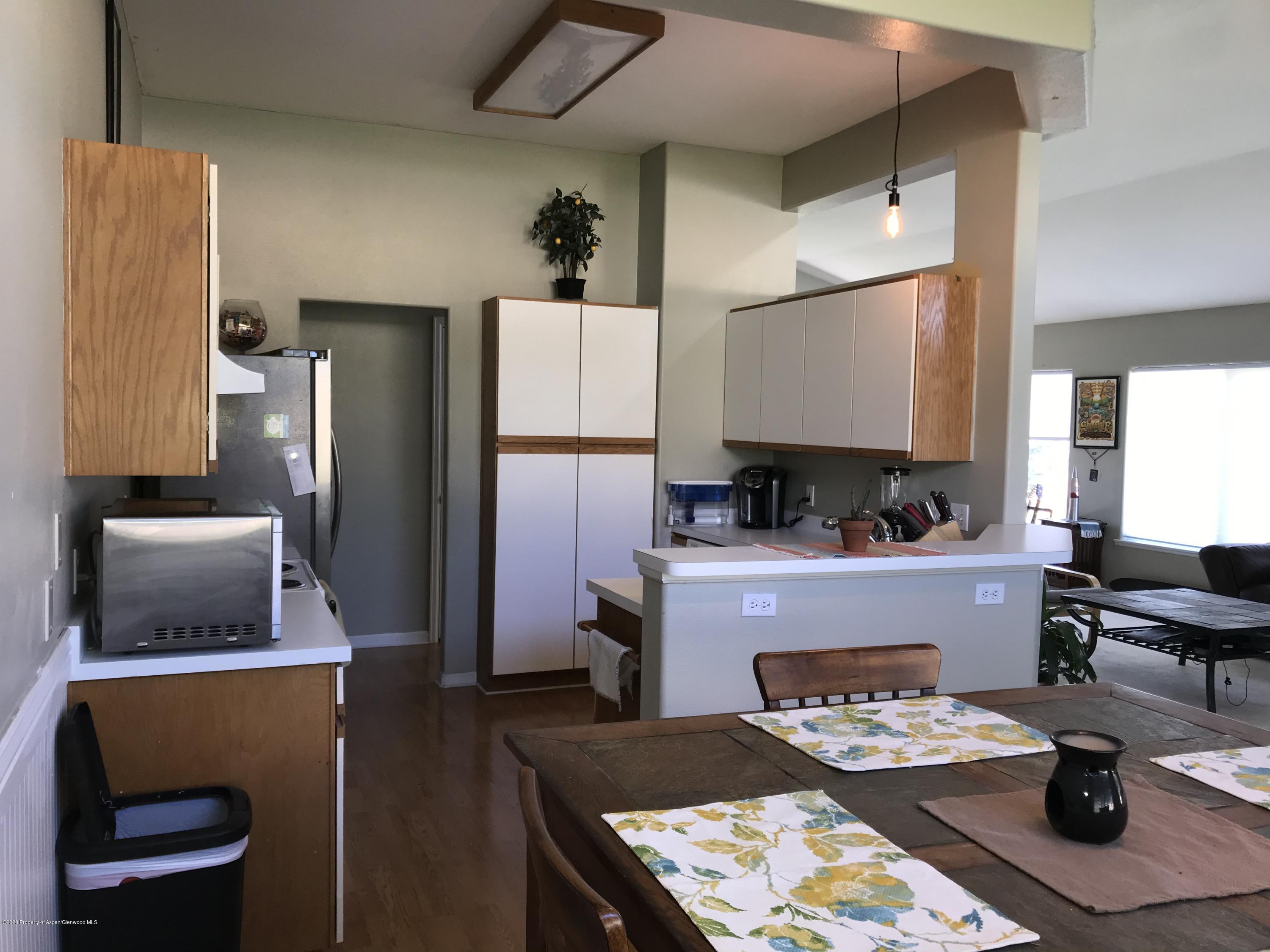16 Limberpine Circle Parachute, CO 81635 - Photo 5 of 22 a kitchen with a refrigerator and a stove top oven