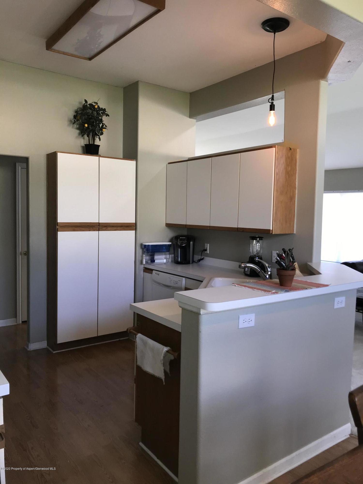 16 Limberpine Circle Parachute, CO 81635 - Photo 6 of 22 a kitchen with a refrigerator a stove a microwave a sink and cabinets