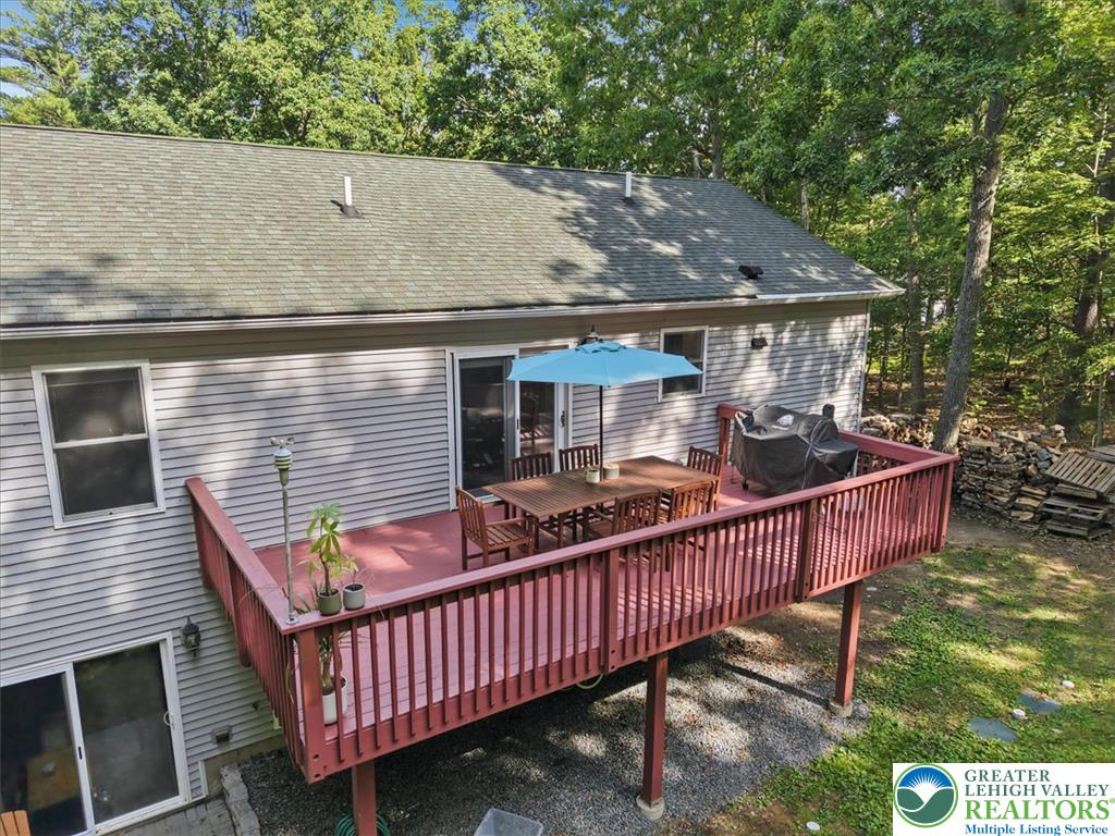 128 Chestnut Street Dingmans Ferry, PA 18328 - Photo 31 of 43 An inviting outdoor deck provides the perfect spot for entertaining, overlooking a wooded backdrop.