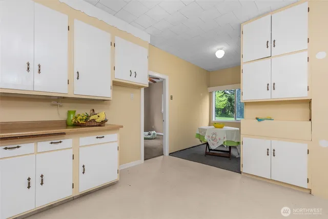 a kitchen with cabinets and window
