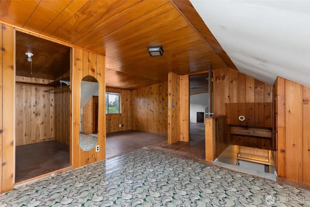 a view of a hallway with wooden shelves
