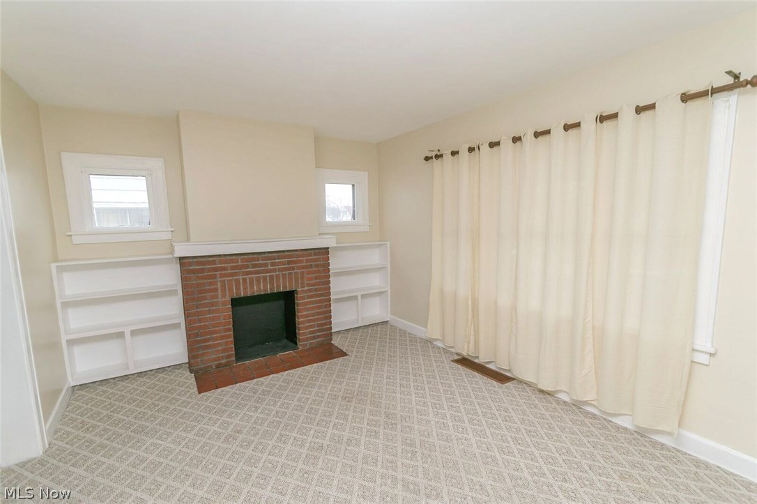 12909 Littleton Road Garfield Heights, OH 44125 - Photo 6 of 24 Custom built-ins accented by windows makes for a great feature wall in the living room.