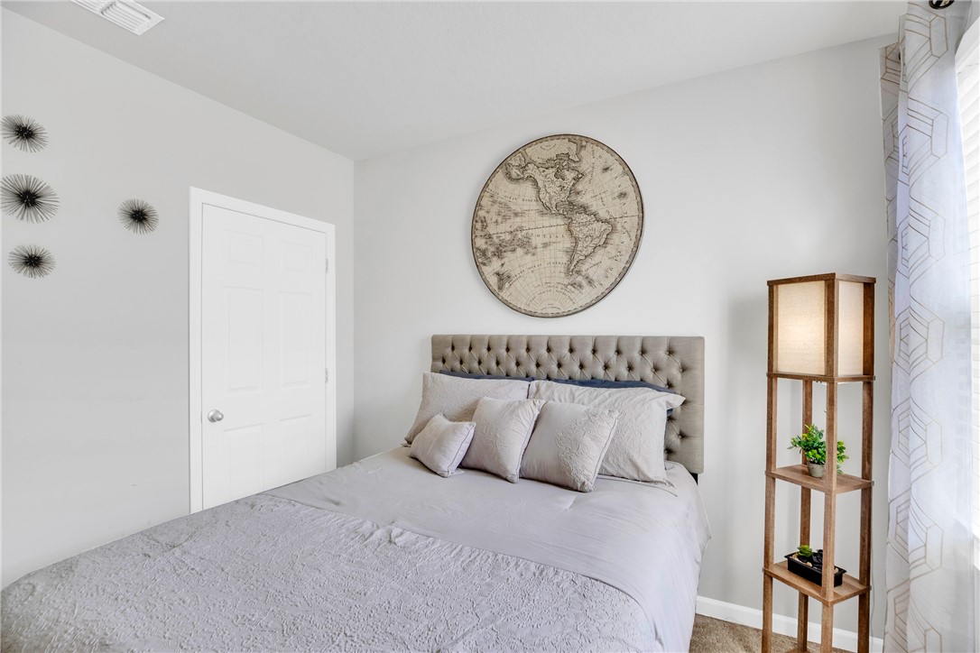 3453 Trinity Circle Fort Pierce, FL 34945 - Photo 22 of 36 a bedroom with a bed and a window