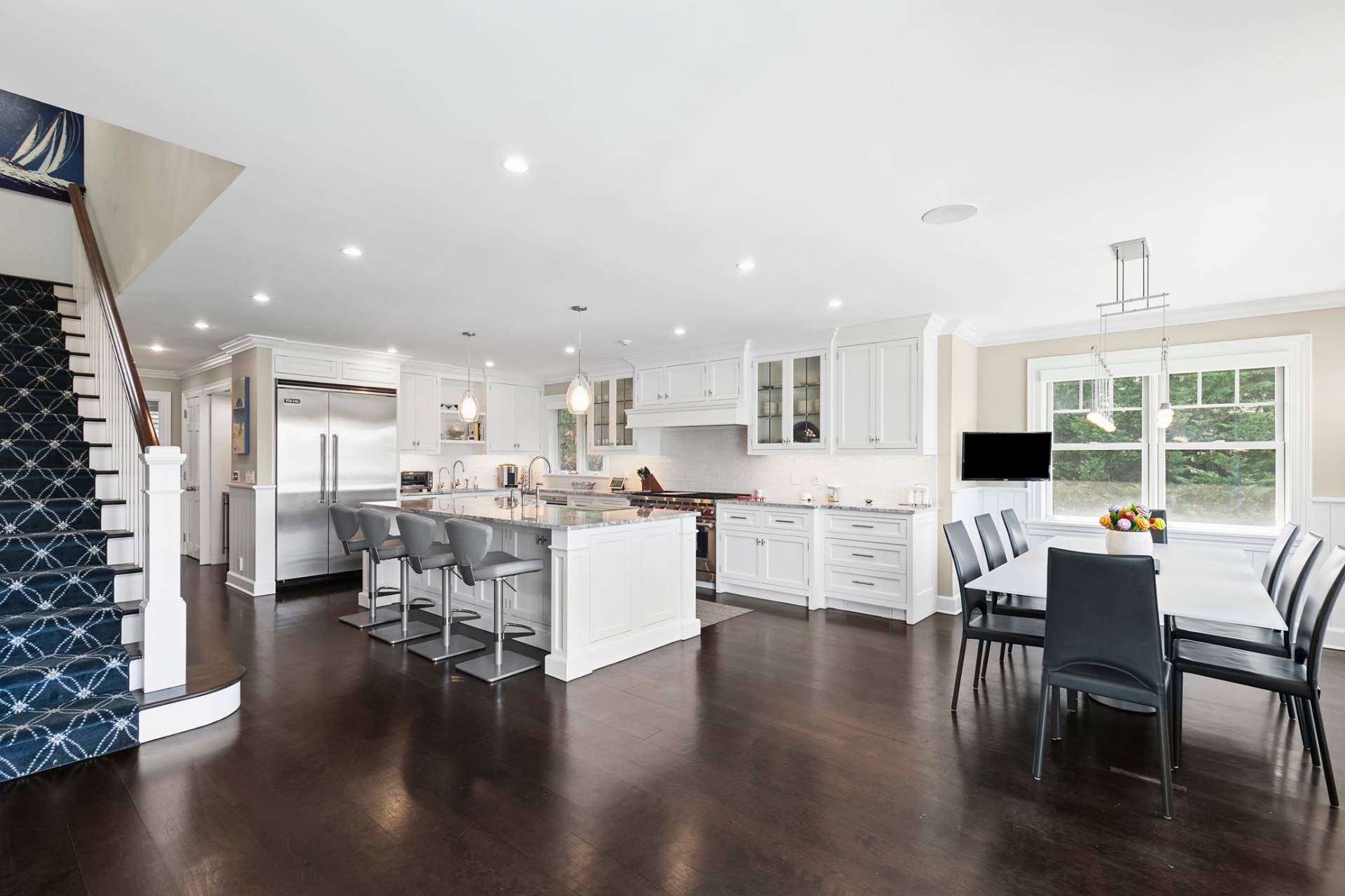 69 Shore Road Westhampton, NY 11977 - Photo 12 of 34 a living room with stainless steel appliances kitchen island granite countertop a table chairs and a stove