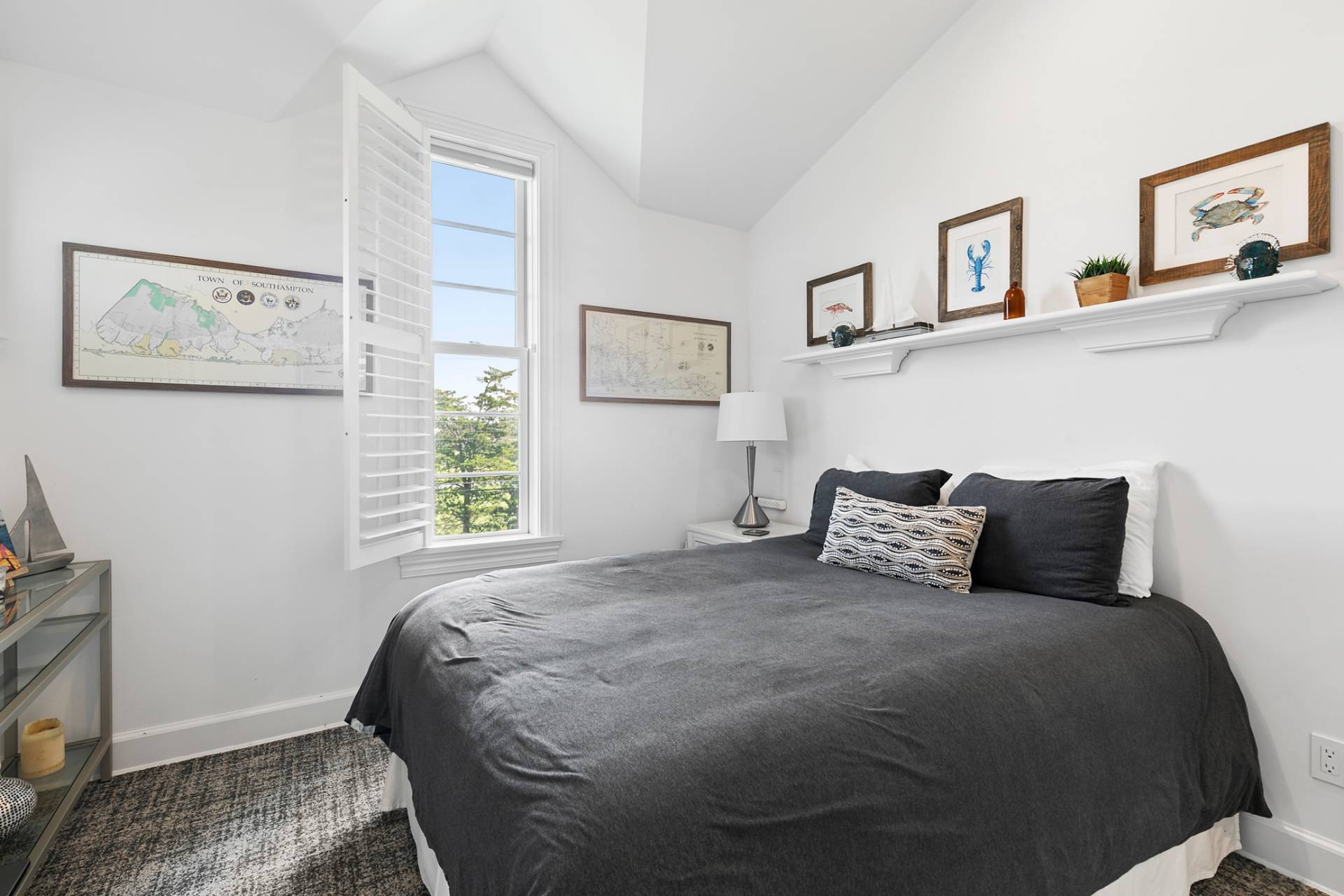 69 Shore Road Westhampton, NY 11977 - Photo 17 of 34 a bedroom with a bed and a window