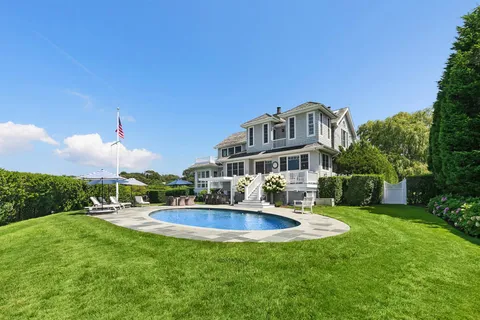 a front view of a house with a yard fire pit table and chairs