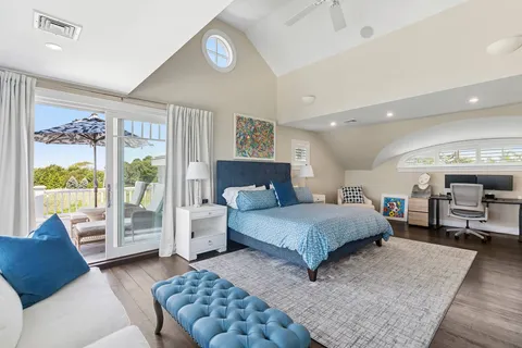 a spacious bedroom with a large bed and a couch