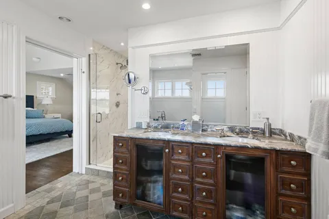 a bathroom with a double vanity sink and a mirror
