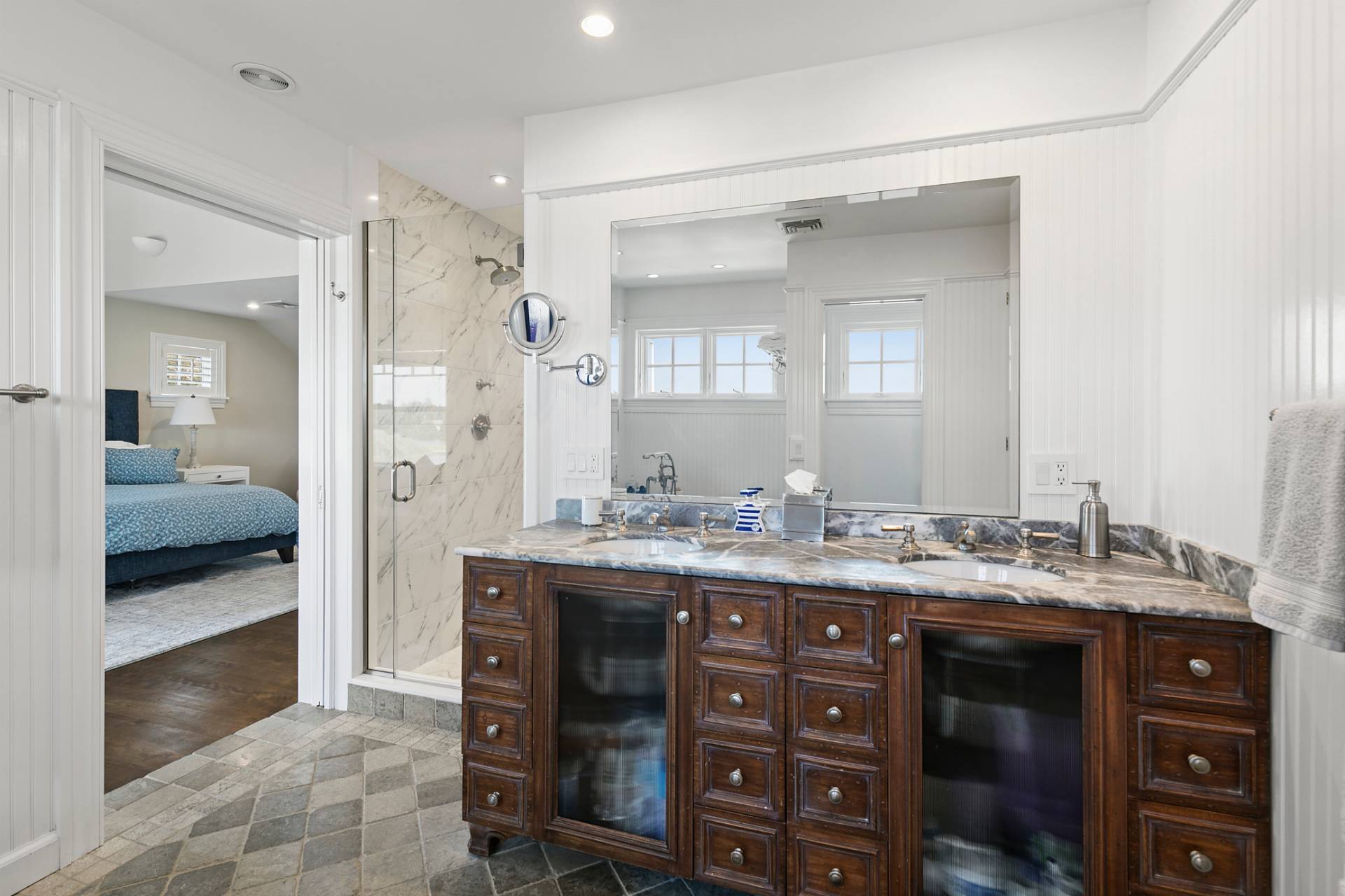 69 Shore Road Westhampton, NY 11977 - Photo 23 of 34 a bathroom with a double vanity sink and a mirror
