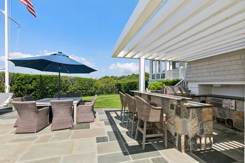 a patio with a patio table and chairs