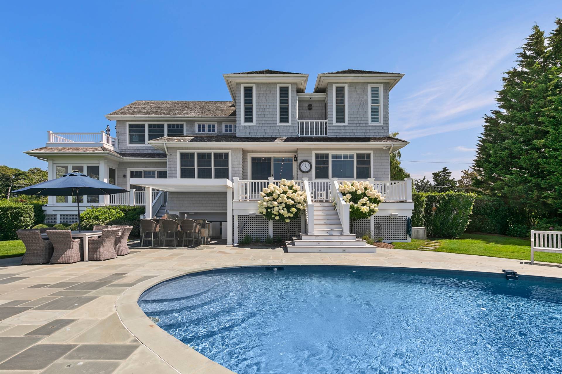 69 Shore Road Westhampton, NY 11977 - Photo 28 of 34 a front view of a house with swimming pool