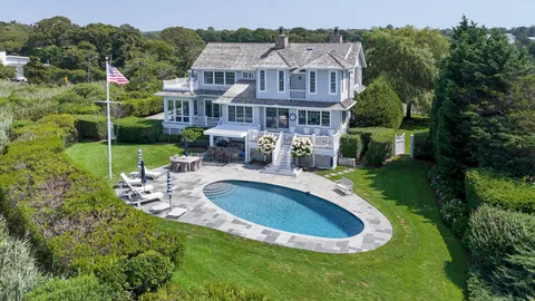 an aerial view of a house with swimming pool and garden