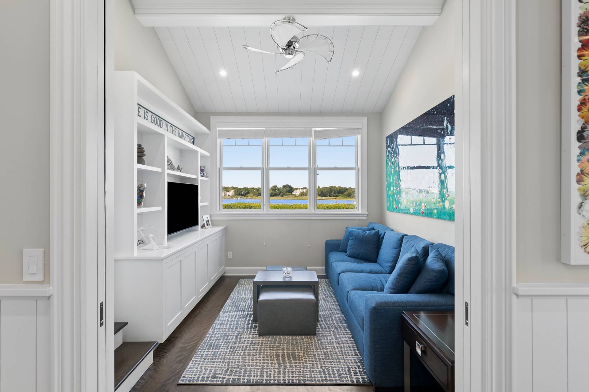 69 Shore Road Westhampton, NY 11977 - Photo 8 of 34 a living room with furniture and a flat screen tv