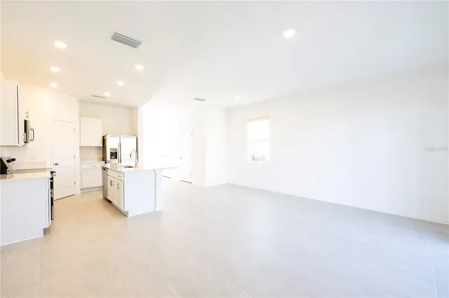 a kitchen with a sink and refrigerator
