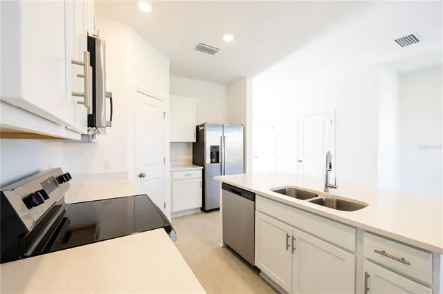 a view of a kitchen with a sink and an oven