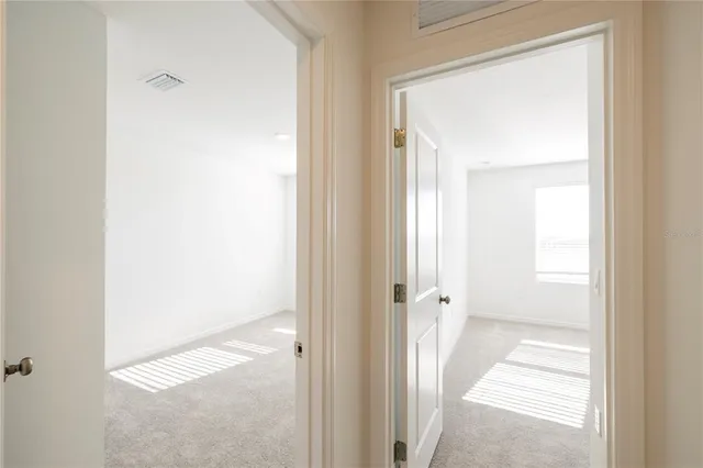 a view of a house with a big yard and large trees