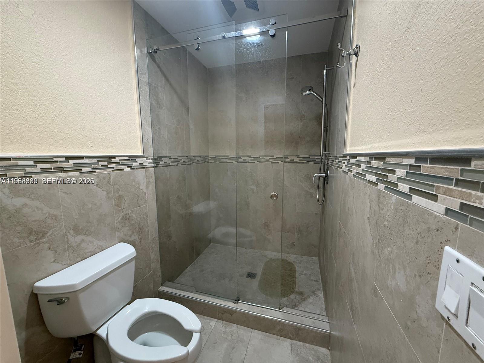 2271 Southwest 30th Terrace Fort Lauderdale, FL 33312 - Photo 12 of 40 a bathroom with a shower a toilet and a sink