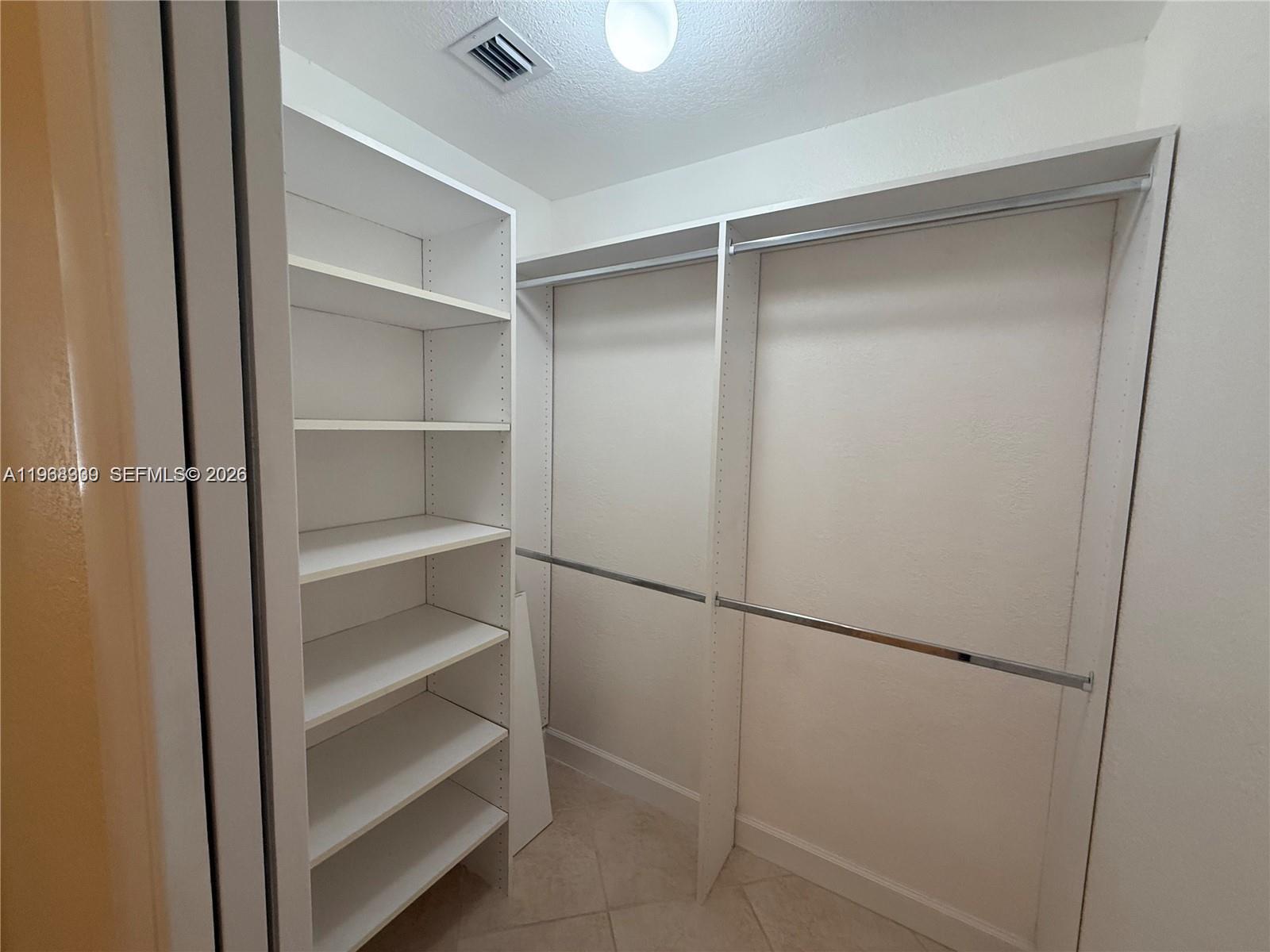 2271 Southwest 30th Terrace Fort Lauderdale, FL 33312 - Photo 14 of 40 a view of walk in closet with empty racks