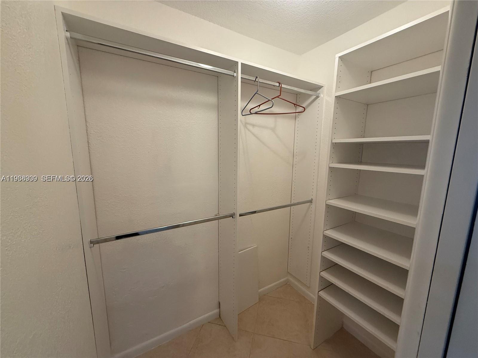 2271 Southwest 30th Terrace Fort Lauderdale, FL 33312 - Photo 16 of 40 a view of walk in closet with empty racks