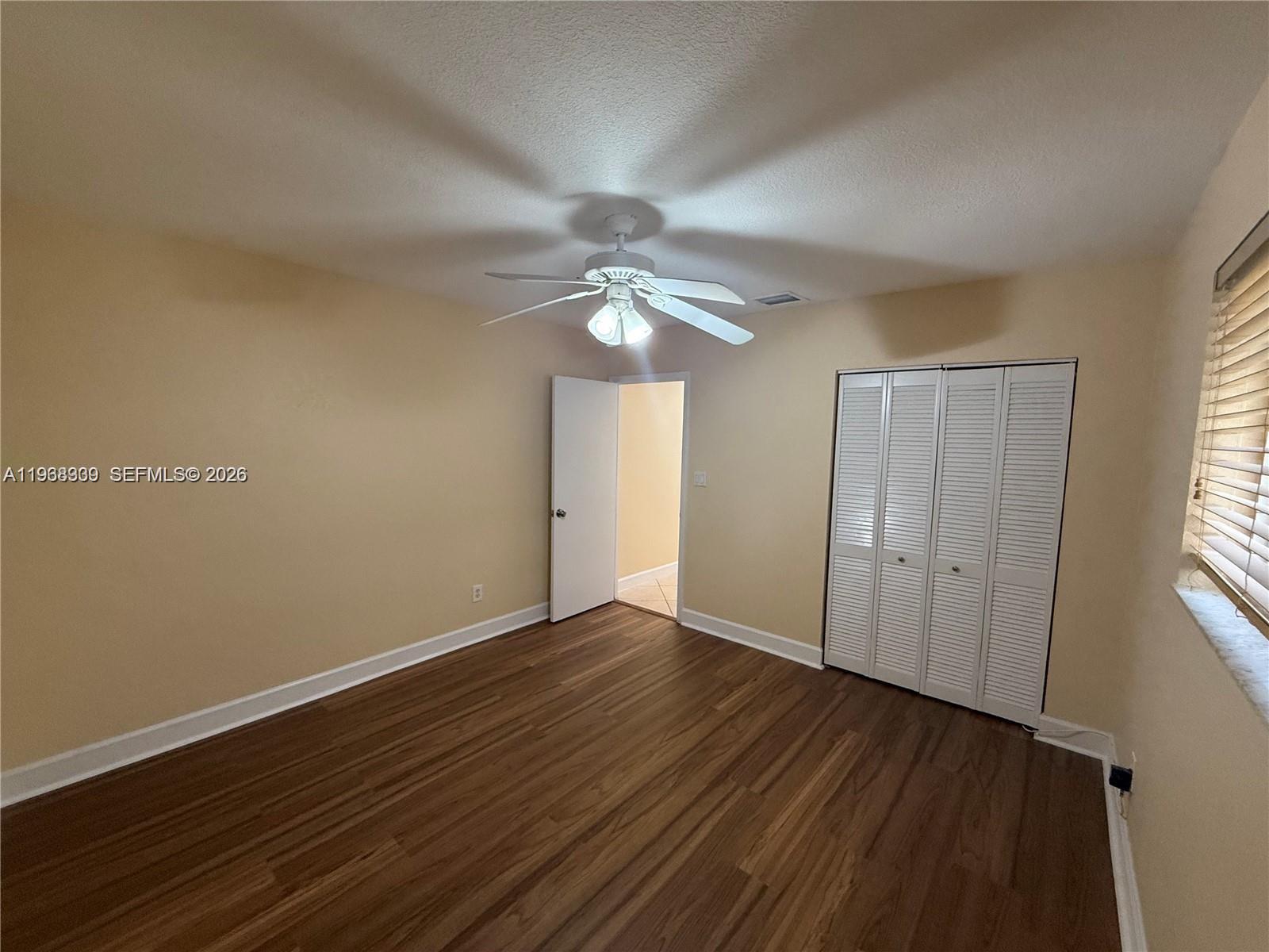 2271 Southwest 30th Terrace Fort Lauderdale, FL 33312 - Photo 20 of 40 a view of an empty room with wooden floor and a window