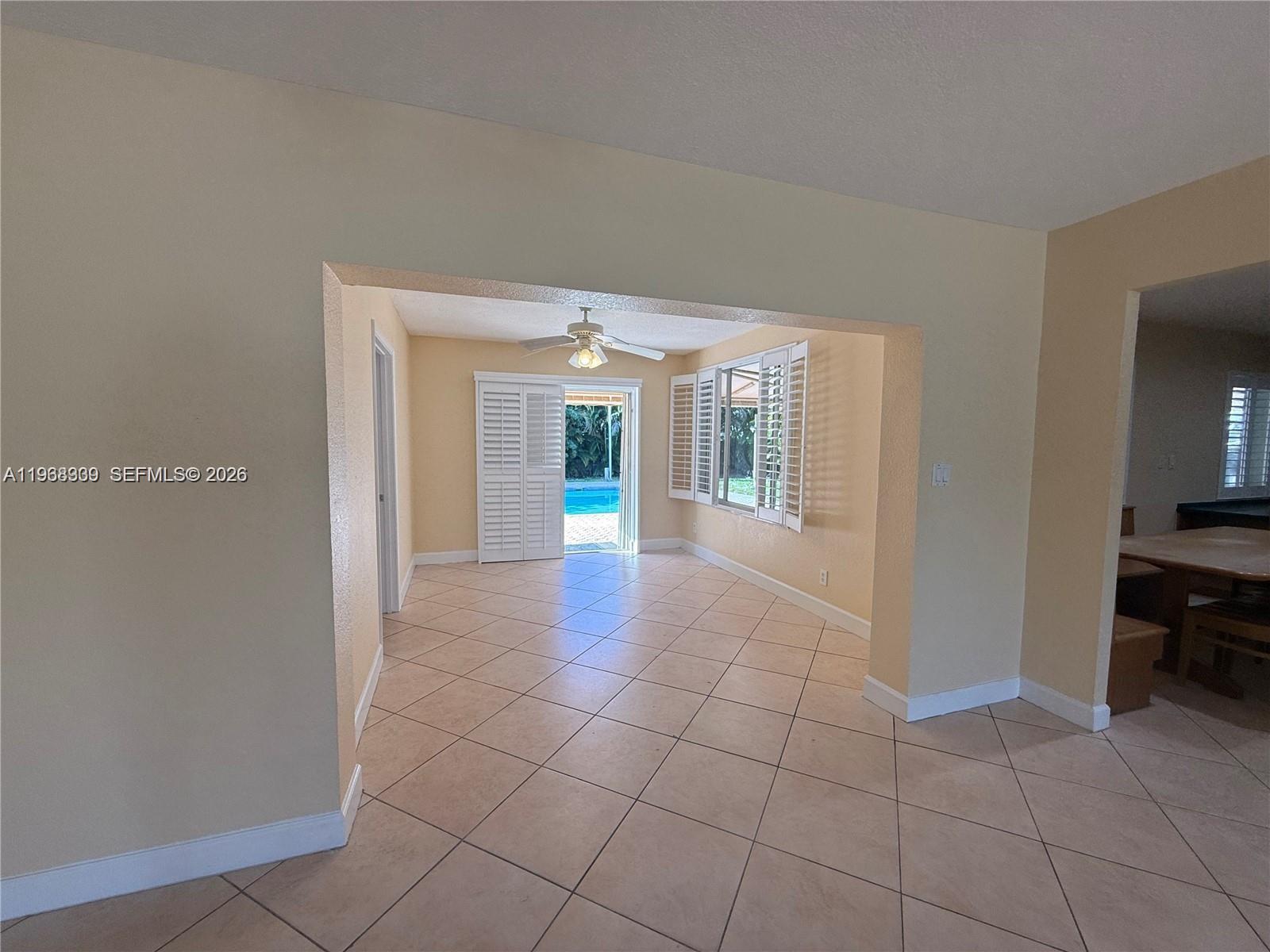 2271 Southwest 30th Terrace Fort Lauderdale, FL 33312 - Photo 21 of 40 a view of a hallway with wooden floor and a living room