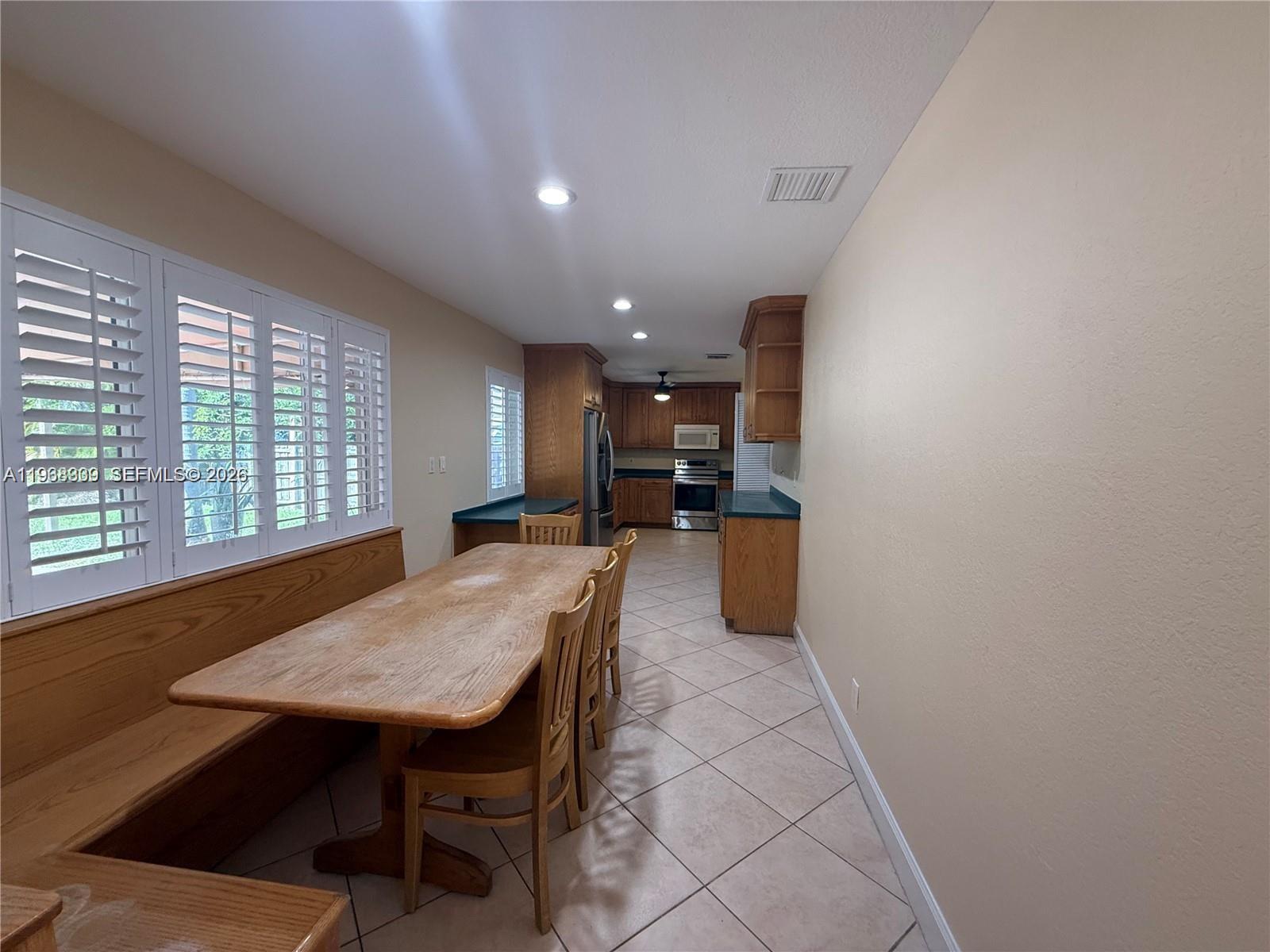2271 Southwest 30th Terrace Fort Lauderdale, FL 33312 - Photo 24 of 40 a kitchen with a table and chairs in it