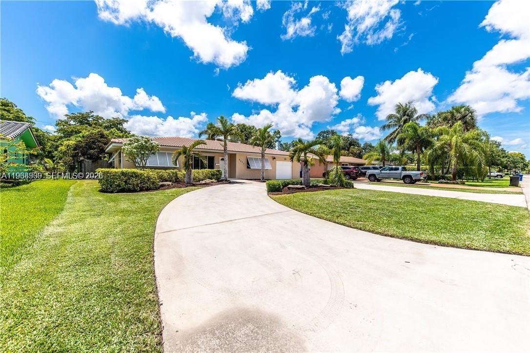 2271 Southwest 30th Terrace Fort Lauderdale, FL 33312 - Photo 33 of 40 a view of a white house with a big yard plants and large trees