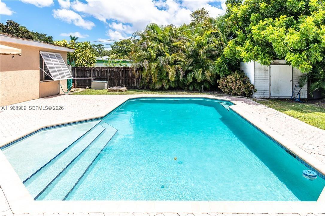 2271 Southwest 30th Terrace Fort Lauderdale, FL 33312 - Photo 35 of 40 a view of a backyard with swimming pool