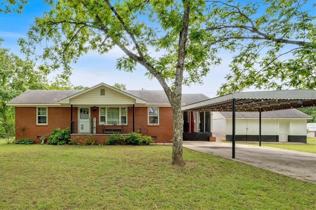 a front view of a house with a garden