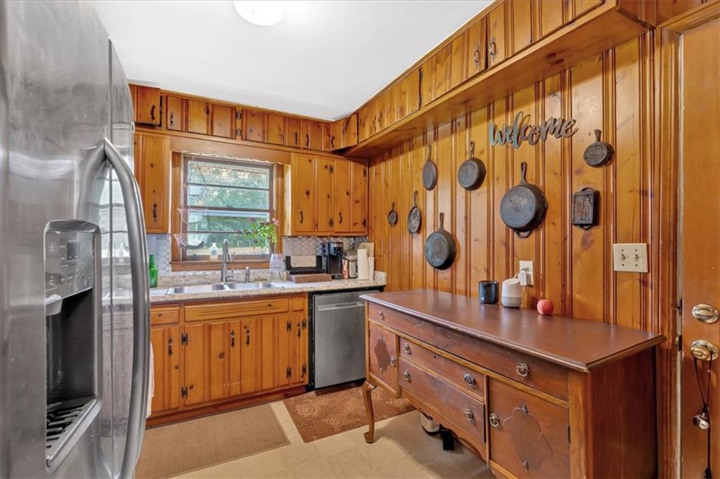 7783 Cantrell Road Douglasville, GA 30135 - Photo 13 of 38 a kitchen with stainless steel appliances a sink and cabinets