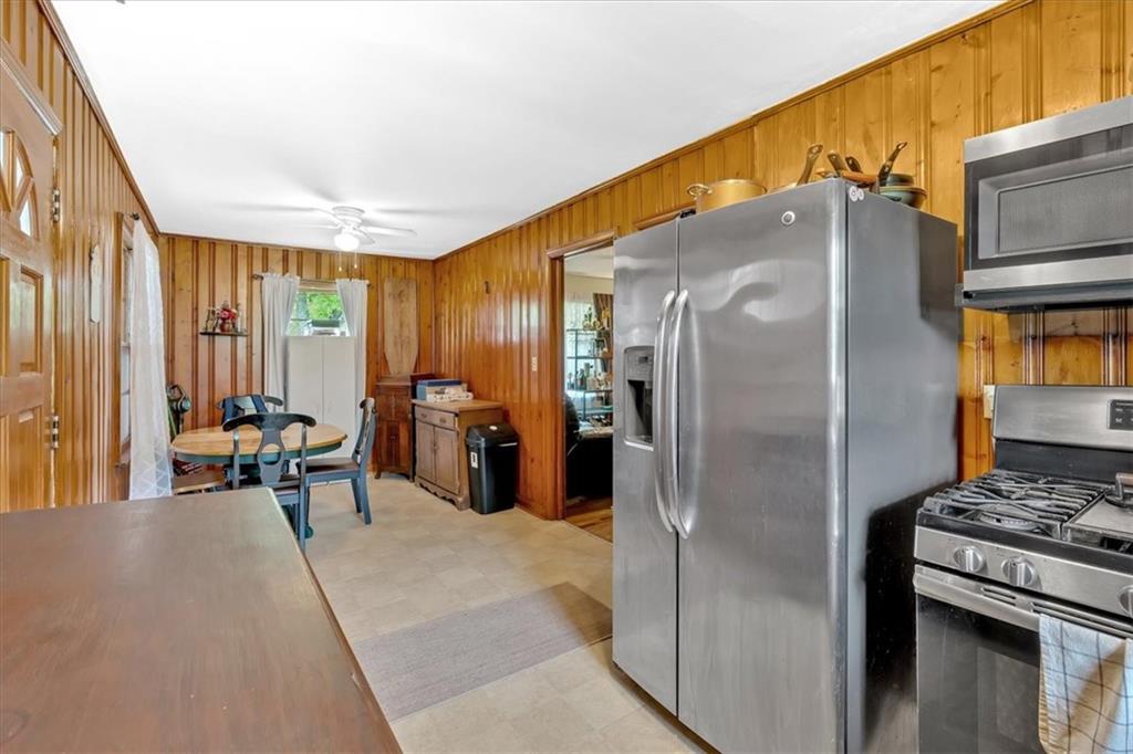 7783 Cantrell Road Douglasville, GA 30135 - Photo 14 of 38 a kitchen with stainless steel appliances a refrigerator and a stove top oven