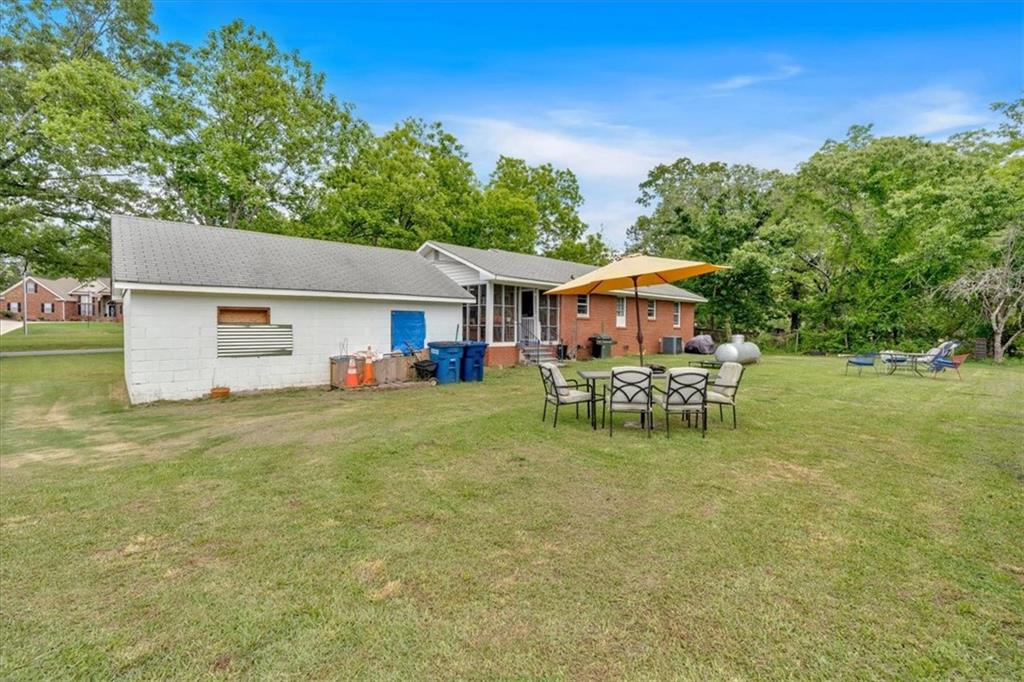 7783 Cantrell Road Douglasville, GA 30135 - Photo 28 of 38 a view of house with backyard and sitting area