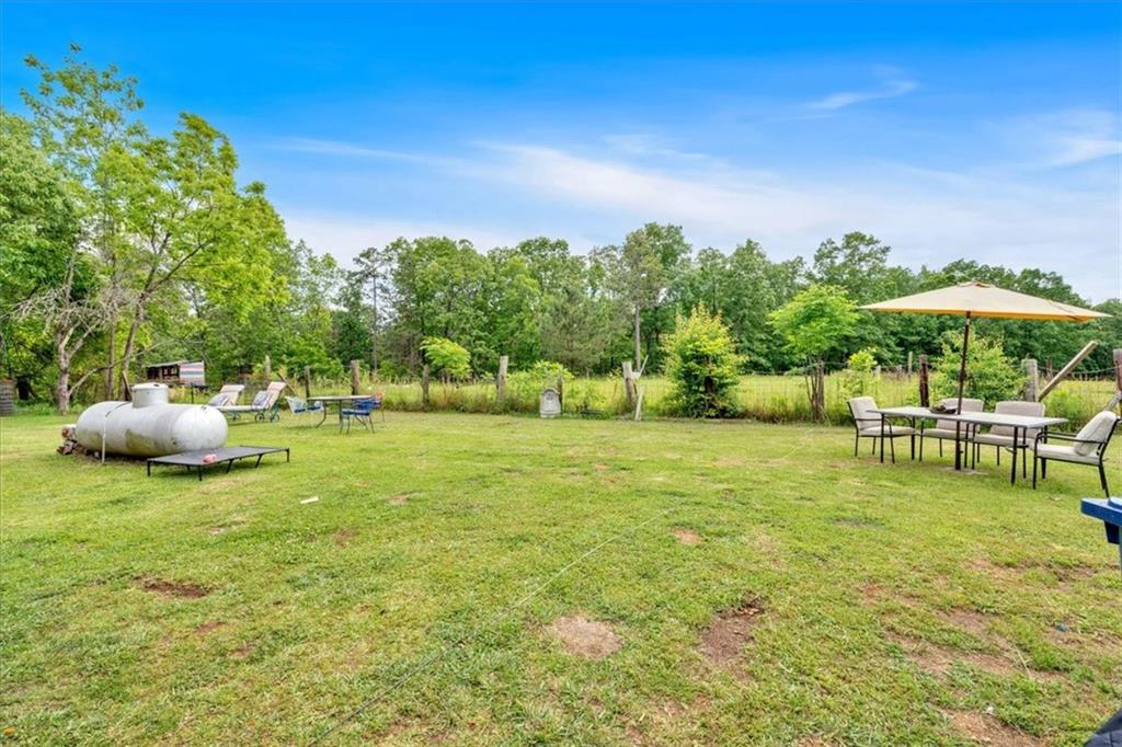 7783 Cantrell Road Douglasville, GA 30135 - Photo 30 of 38 a backyard of a house with table and chairs