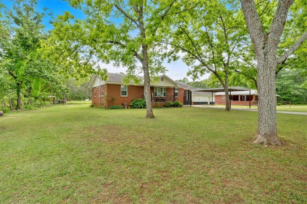 7783 Cantrell Road Douglasville, GA 30135 - Photo 4 of 38 front view of a house with a big yard