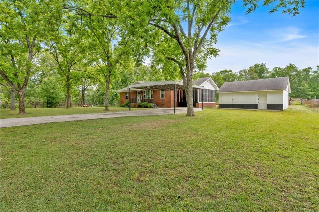 7783 Cantrell Road Douglasville, GA 30135 - Photo 5 of 38 a view of a house with yard and sitting area