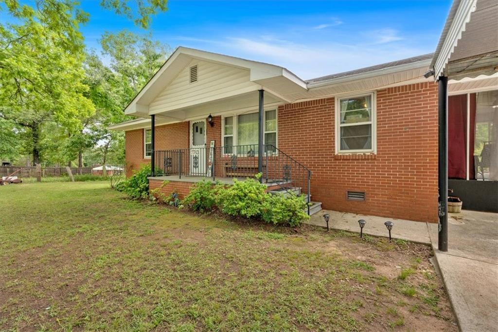 7783 Cantrell Road Douglasville, GA 30135 - Photo 7 of 38 a front view of a house with garden