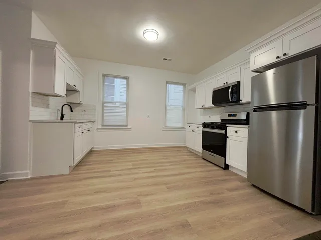 a kitchen with stainless steel appliances a refrigerator stove microwave and sink
