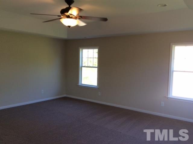 136 Locke Woods Road Raleigh, NC 27603 - Photo 11 of 18 an empty room with a window and a fan