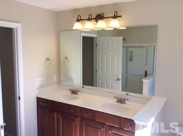 136 Locke Woods Road Raleigh, NC 27603 - Photo 12 of 18 a bathroom with a sink and a mirror